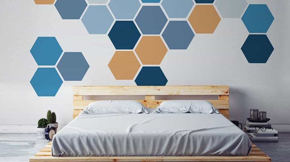 A accent wall paint design idea with colourful hexagon with a bed