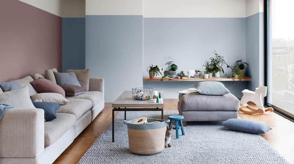 A pale blue wall paint design idea with sofas and table