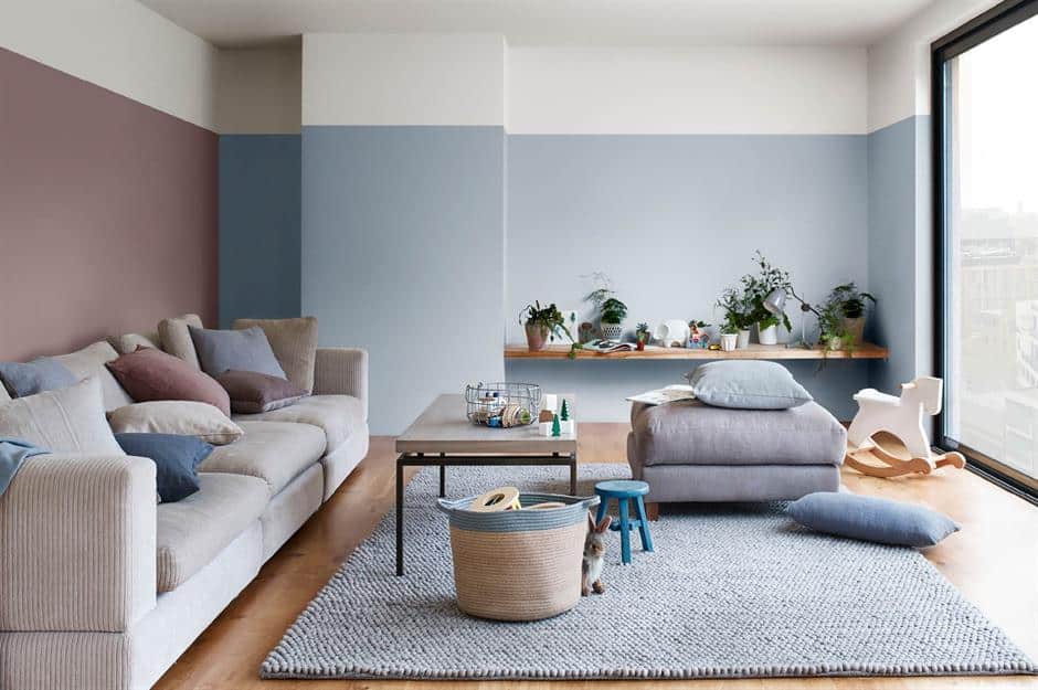 A pale blue wall paint design idea with sofas and table
