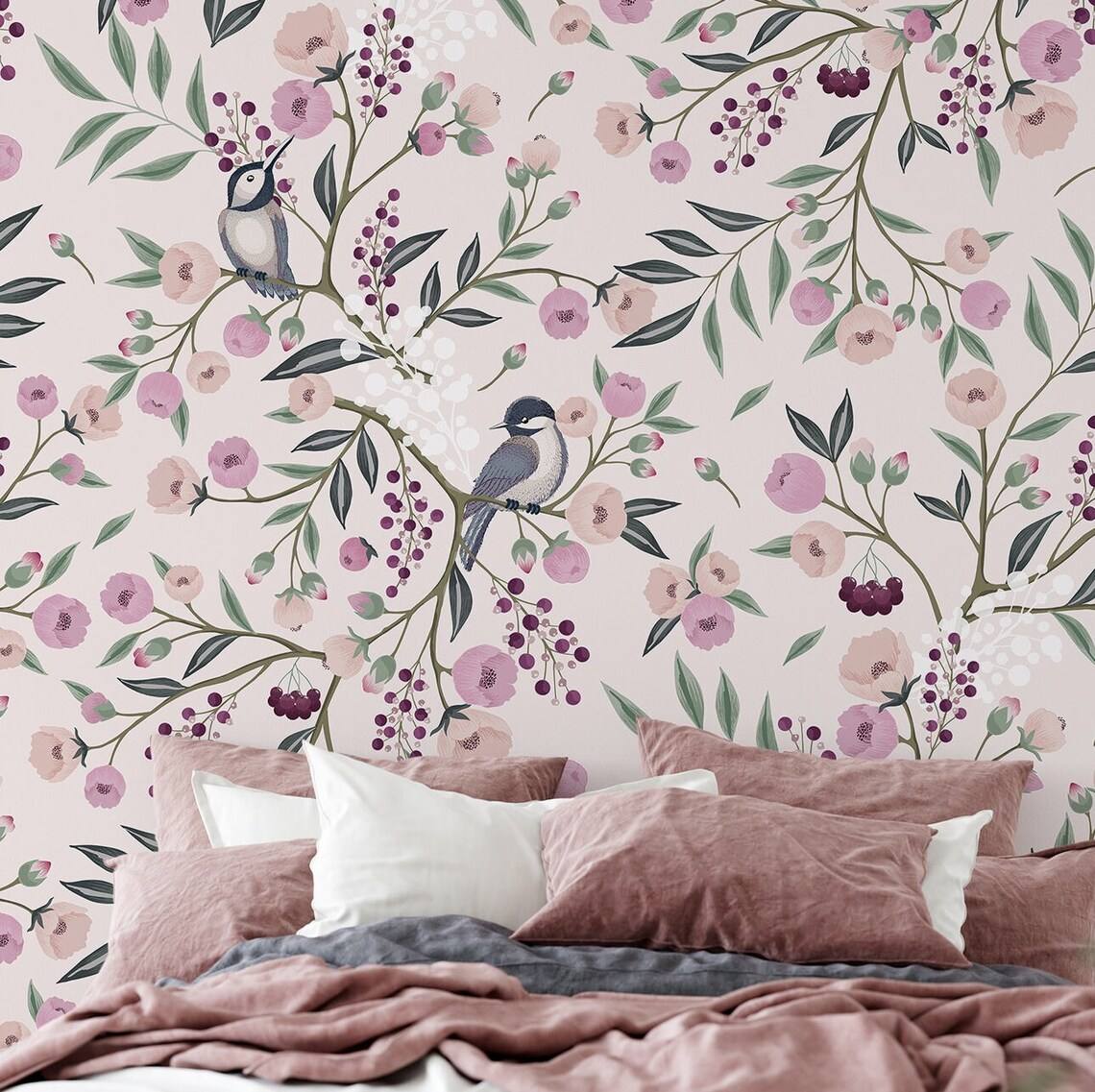 pink room with a fl، wallpaper, a bed, pillows and blanket