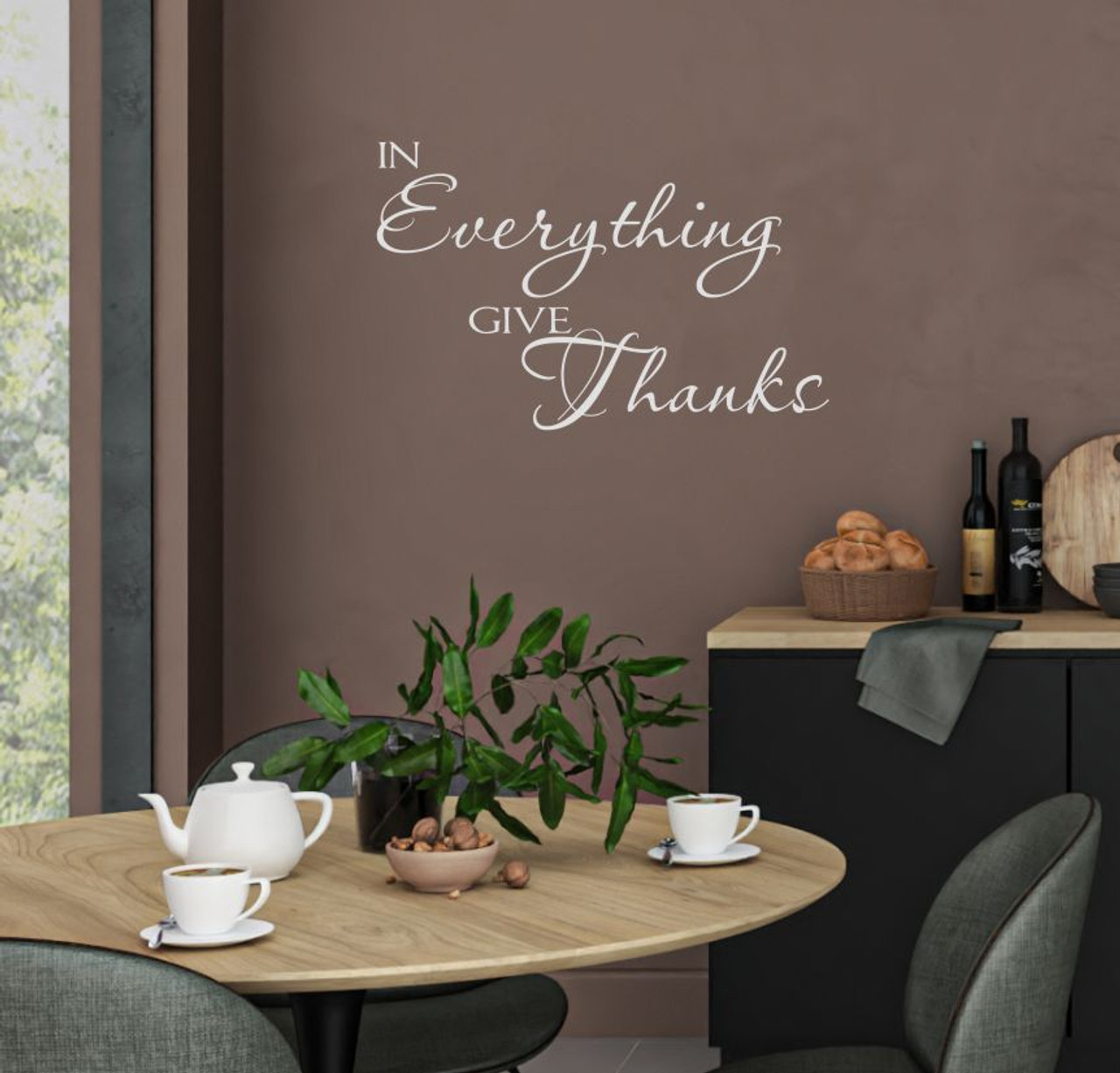 A quote on the kitchen wall with a table, accessories and countertop