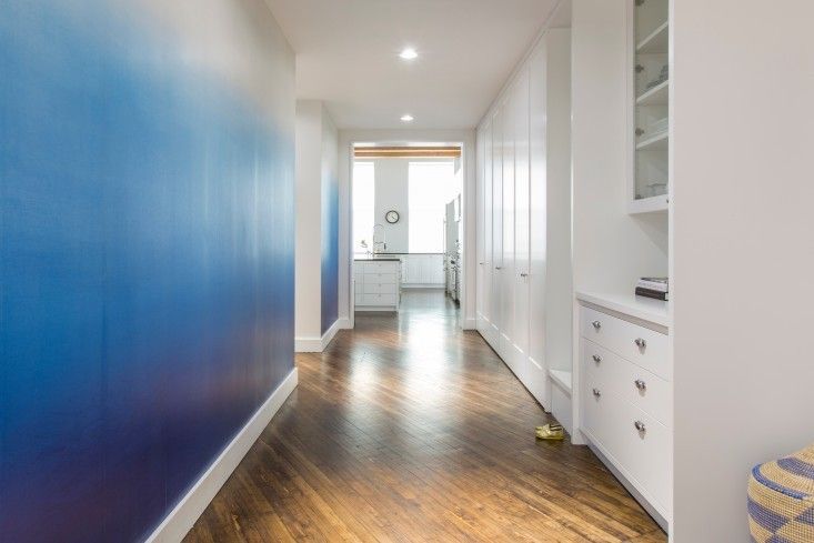Ombre hallway wall paint design idea in blue and white with cabinets
