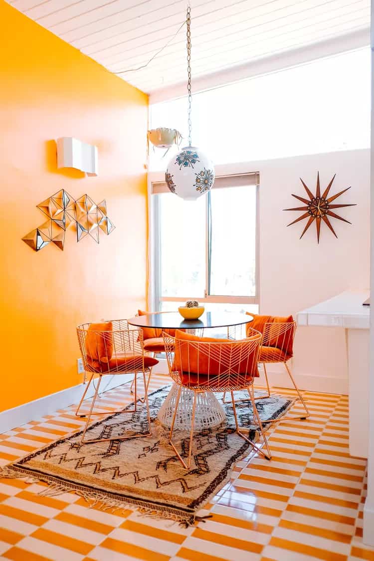 A super bright dining area in orange with dining table