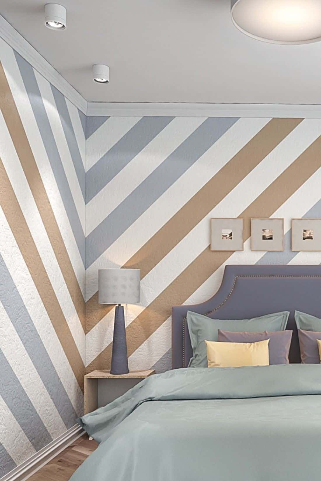 A bedroom wall with stripe wall paint design idea along with a bed and a lamp