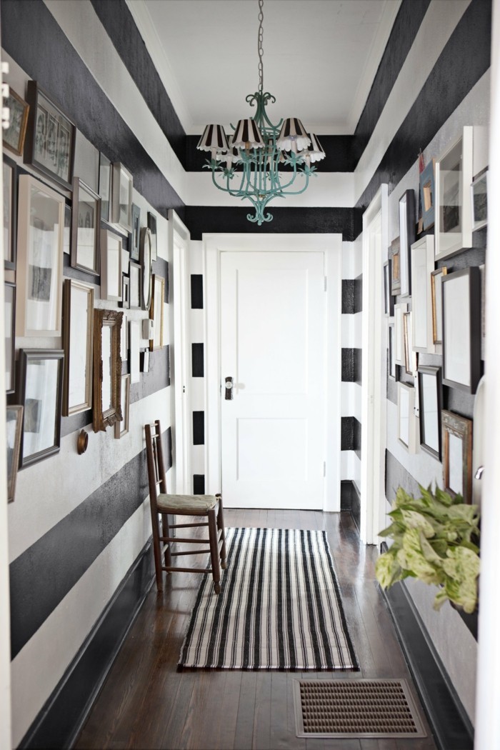 Horizontal stripes wall paint design idea in hallway with paintings