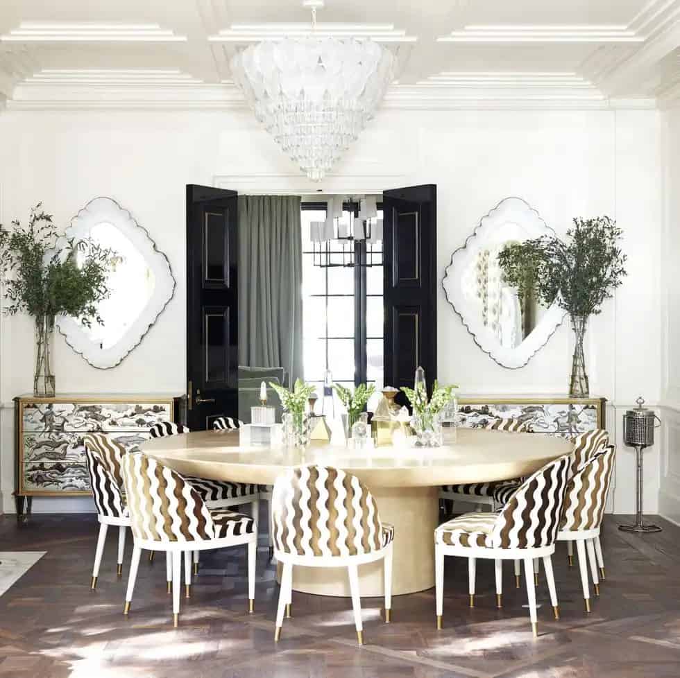 A white dining area with dining table and mirrors