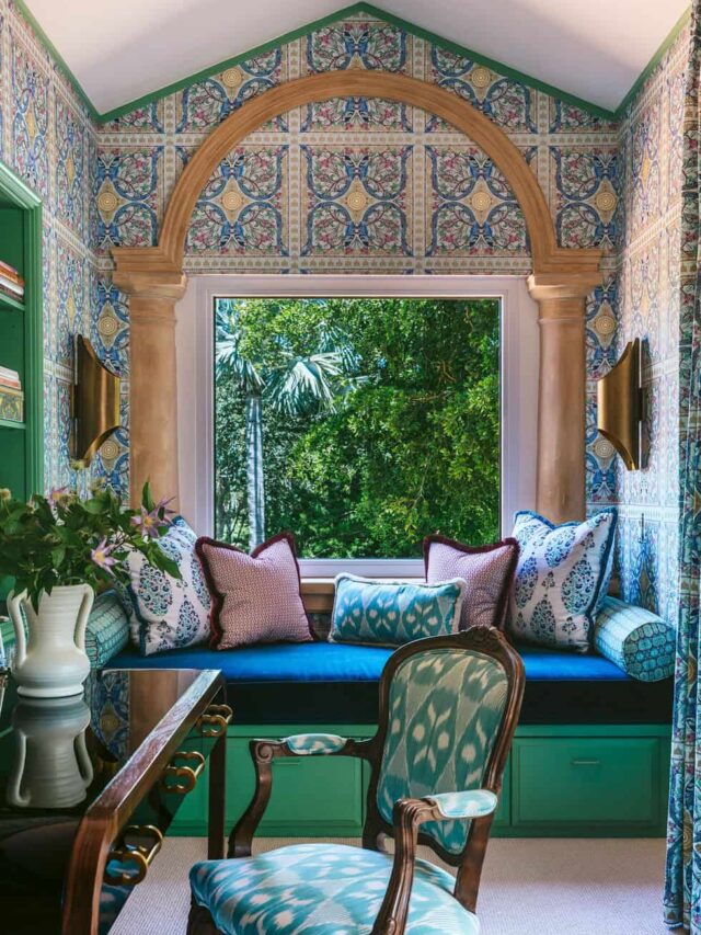 vintage-style living room with green furnishings and a large picture window and green patterned accent walls