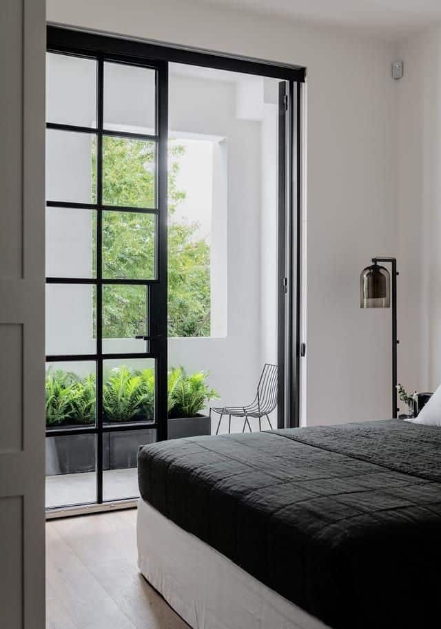 glass gate for the bedroom with a white bed