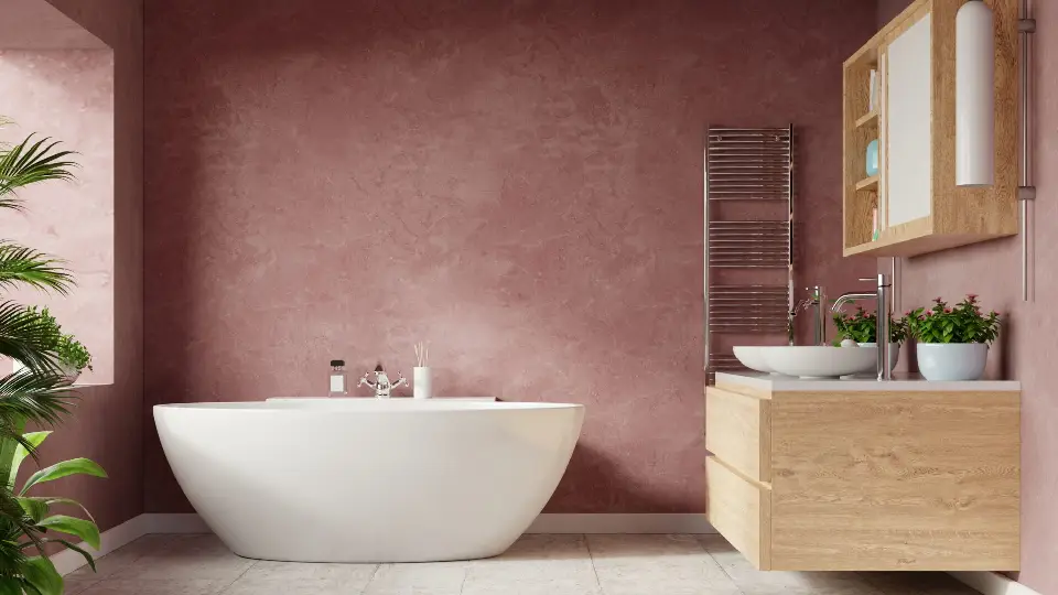 A premium bathroom design having functional sanitaryware, a wooden vanity towards the right, white marble bathtub