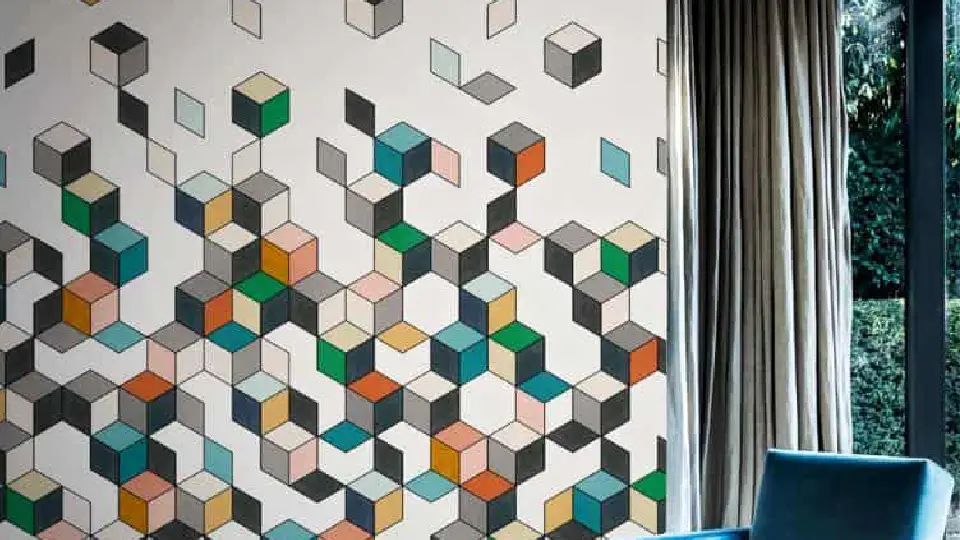 A cube design wall with a single sofa chair in the front