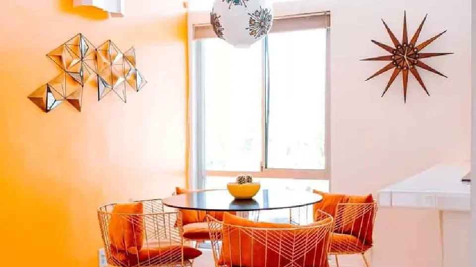 A super bright dining area in orange with dining table