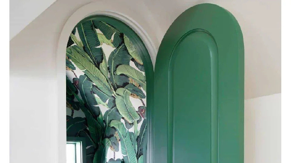 Green wooden arched door in bathroom