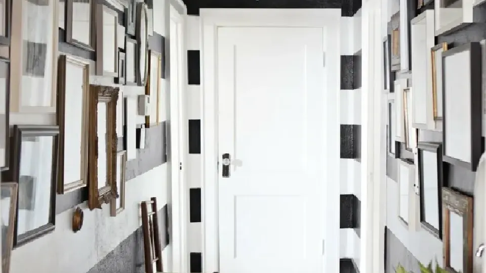 Horizontal stripes in hallway with paintings