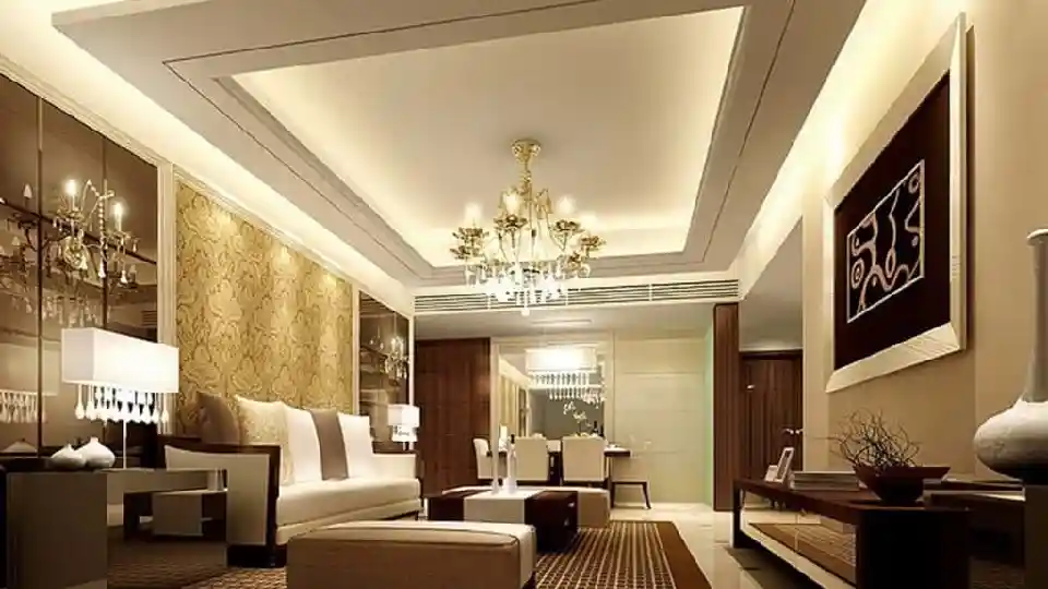 A living room setting with neutral colours false ceiling