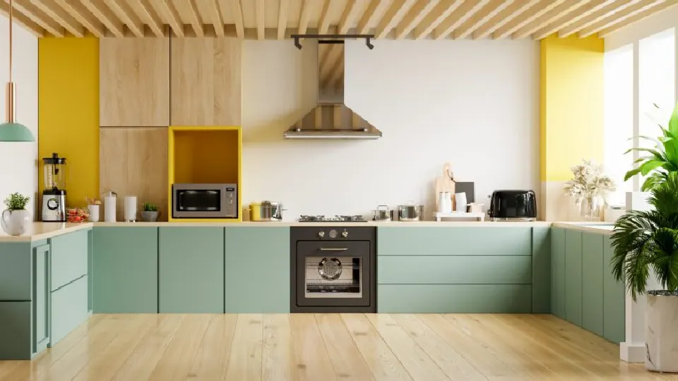 cooking area design with brown wooden floors, chimney, appliances and green cabinets