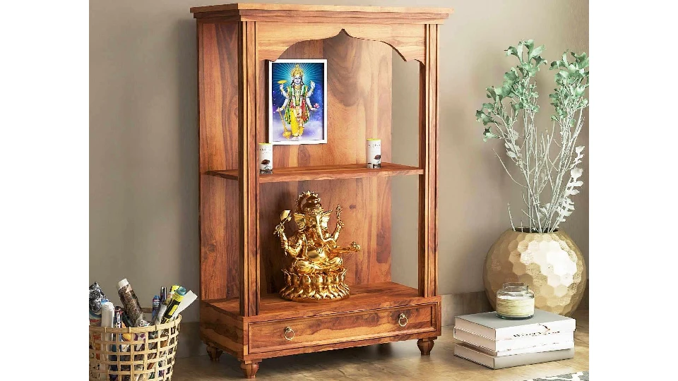 brown prayer unit with a rug, plant and idols