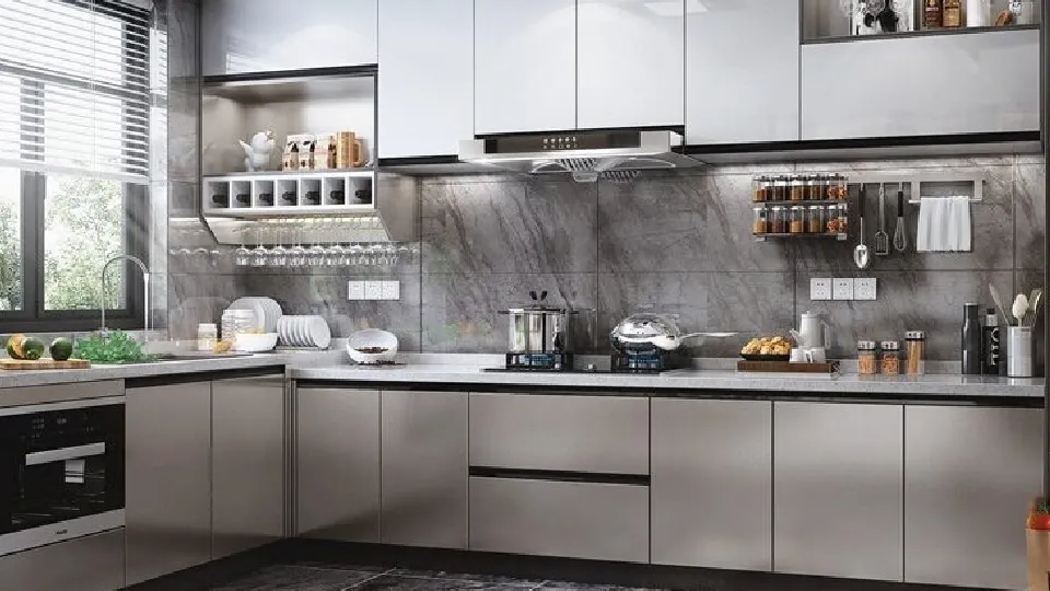 silver cooking area with white cupboards, appliances and cabinets