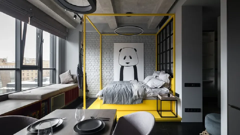 Monochromatic studio apartment with table, chairs and bed