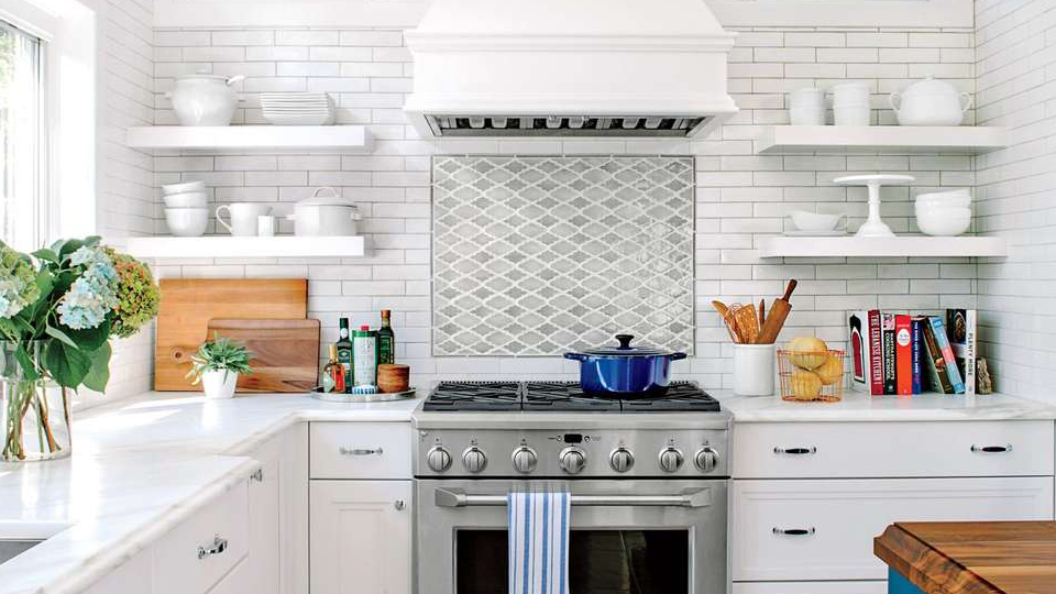 A luxury cooking space with white theme, white shelves, cabinets, appliances, and countertop
