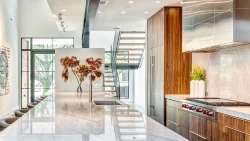 A modern, luxurious white kitchen with a glossy finish, elegant luxury modern kitchen designs