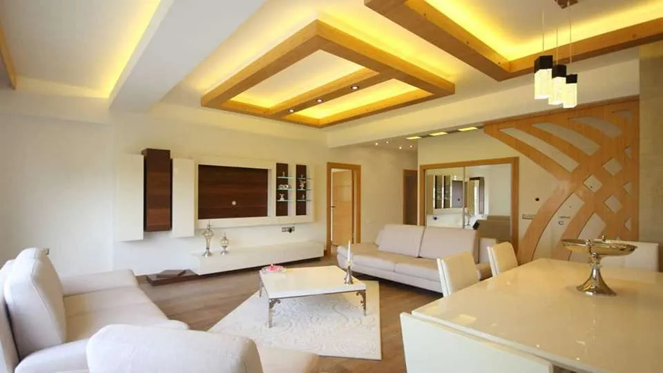 A false ceiling frames the room with subtle grace,Hiding wires and pipes while enhancing space.