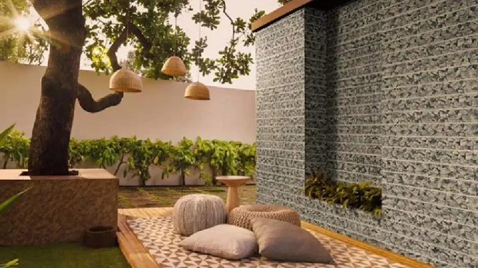 Outdoor seating with patterns on the wall and a tree