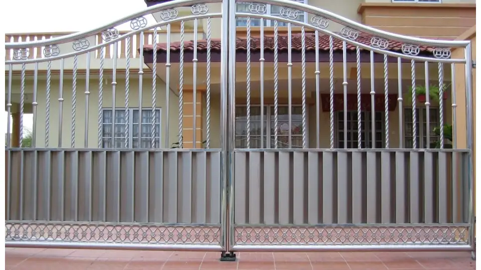 arched stainless steel gate outside a ،use