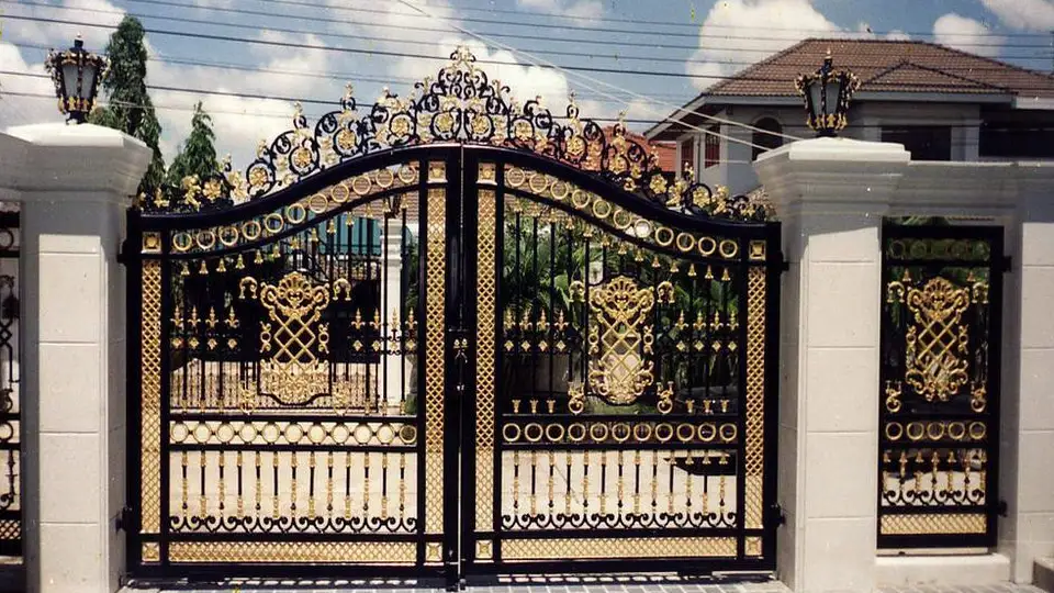 Golden highlights in a black wrought iron gate