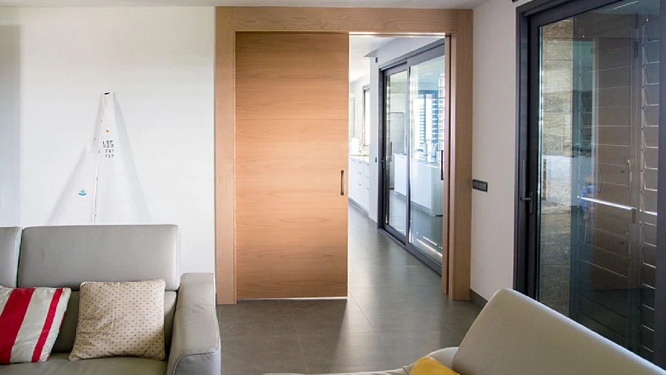 brown pocket door in a living room with sofa inside a home in India