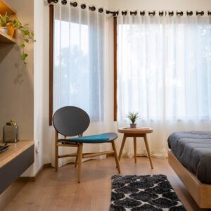 minimalistic bedroom interior design with wood flooring, sheer curtains, furniture