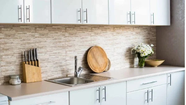 white cabinets, t-bar kitchen handles, kitchen utensils, flower vase