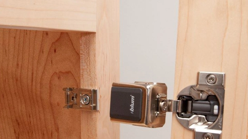blum concealed clip on installed on a wooden cabinet