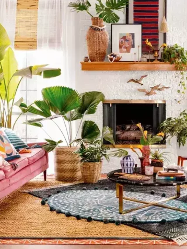 Bohemian decor, pink sofa, blue rug, decorative elements, houseplants, photo frames