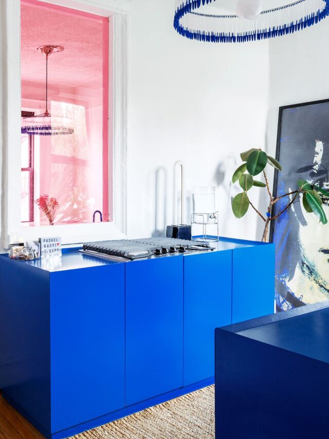 modern minimalistic kitchen design with pink stained glass windows and vibrant blue island