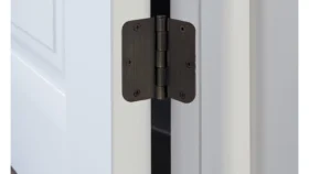 a brown butt hinge on a white door