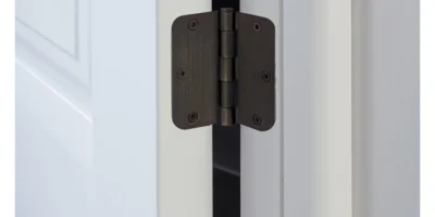 a brown butt hinge on a white door