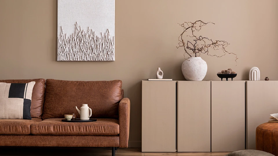 Terracota brown painted wall with a deep coffee shade sofa 