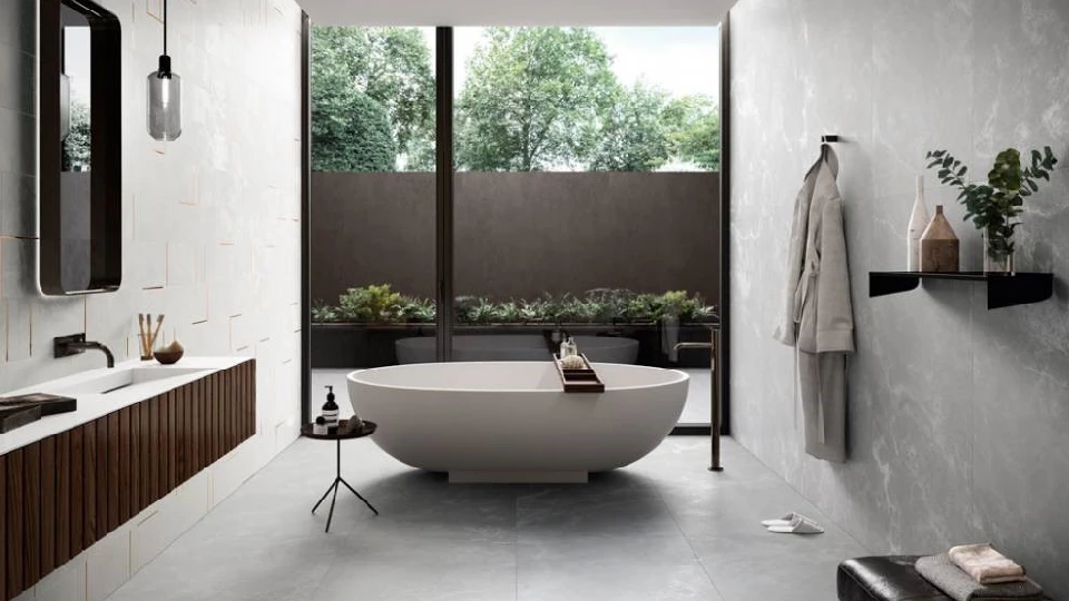 grey bathroom with white bathtub washbasin, mirror, shelf and pendant light