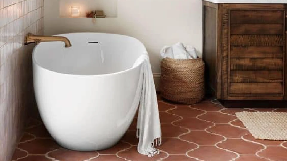 white bathrub in bathroom with red tiles