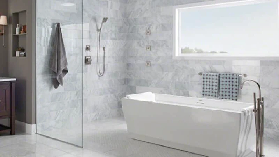 grey bathroom with bathtub and tiles