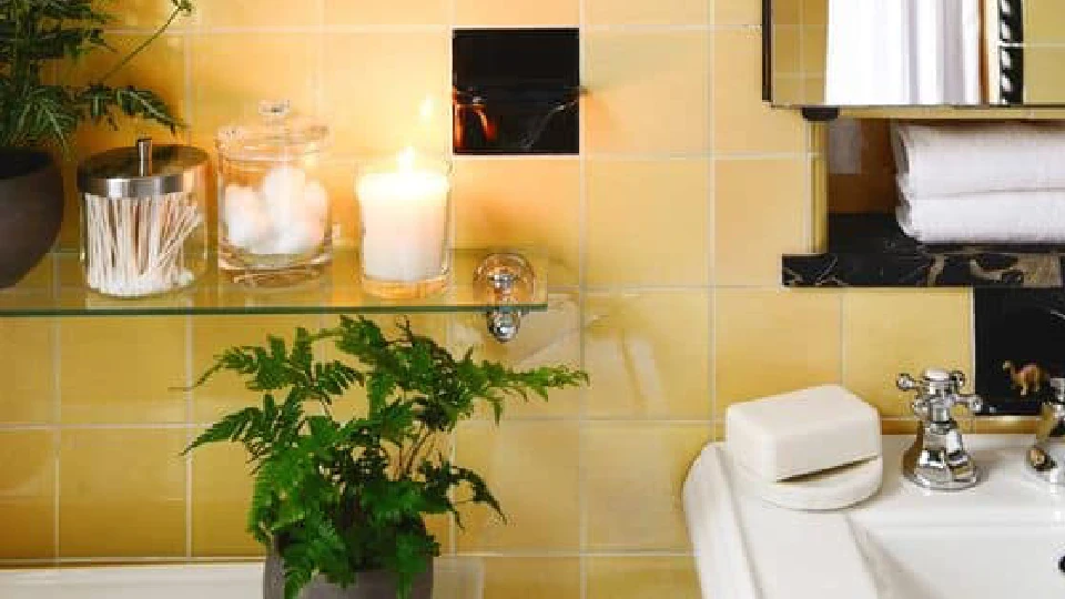 Yellow bathroom with candles and plants