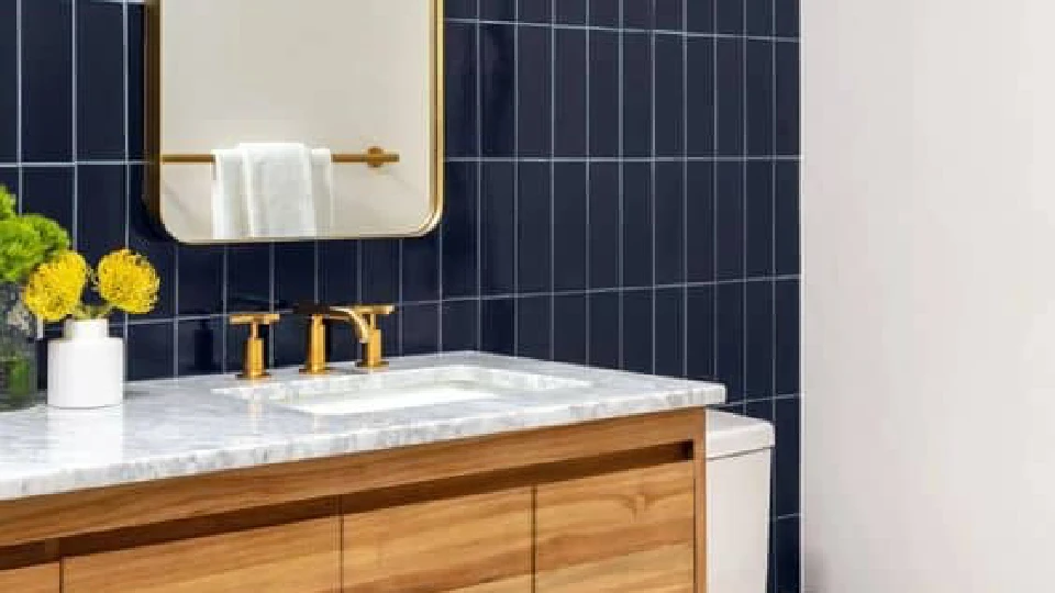 blue and brown coloured bathroom with golden taps and faucets