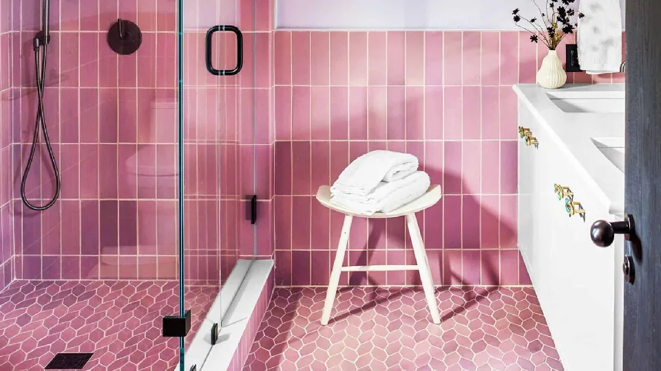 A light pink bathroom design with lights, chair and more