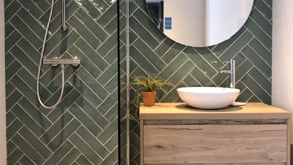 Green wall tiles paired with brown floor tiles in the bathroom