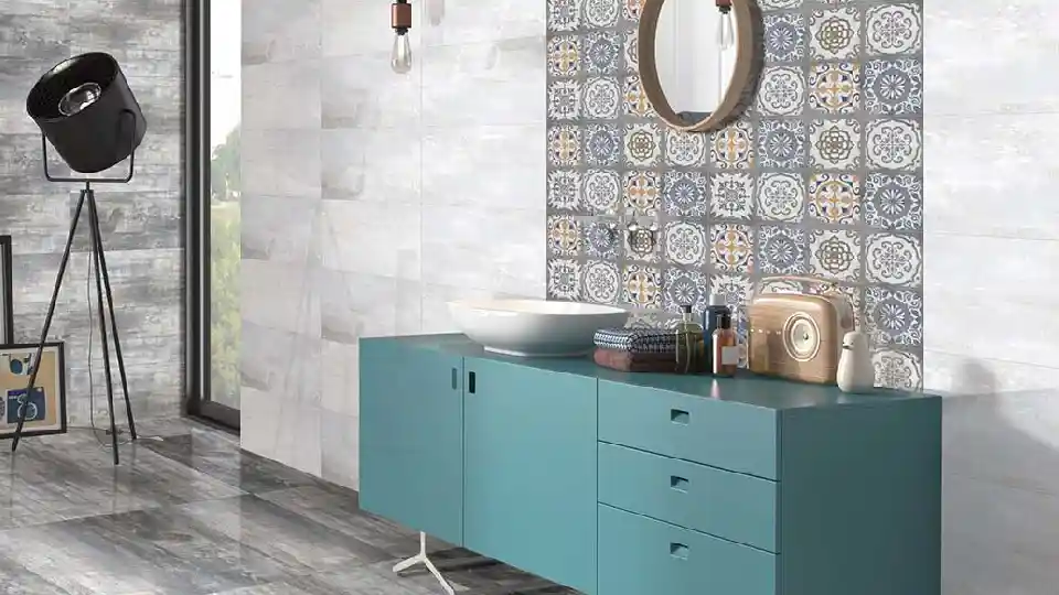 Matt tiles with blue cabinets, white washbasin, decorative matt tiles and round mirror
