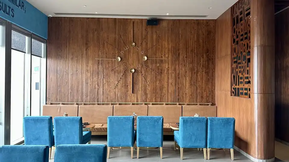 Beautiful wall panellings in a lounge area with blue chairs - western red & yellow cedar