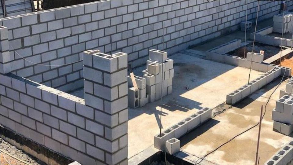 grey concrete blocks laid together to build walls. Hindustan tiles shop in ranchi, paver block manufacturer in India, kerb stone manufacturer