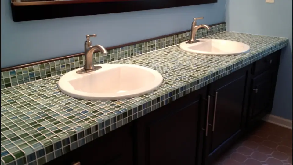 Mosaic flooring cost per sq ft on bathroom countertop in black, blue and grey colour with two bathroom sinks