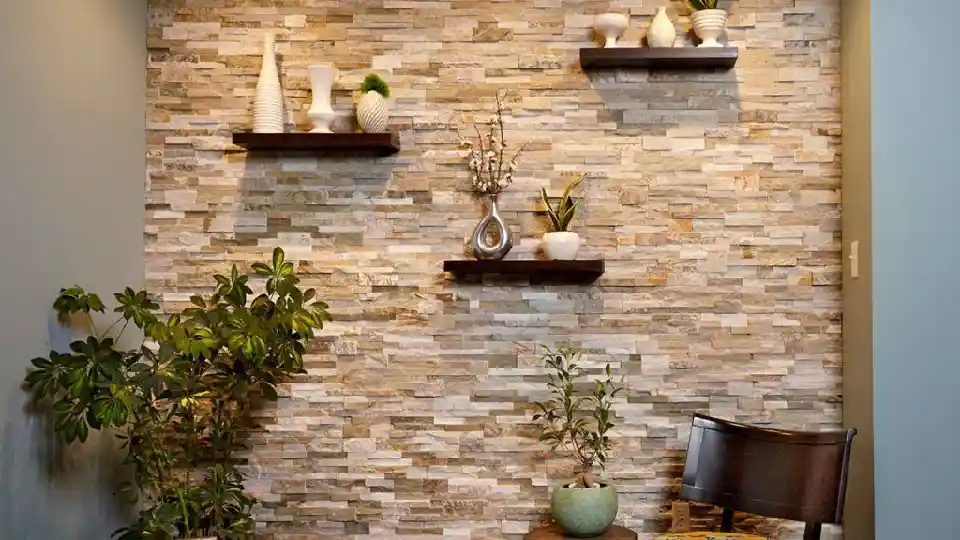 earthy living room with beige rock tiles in the background, decorative pieces and plants on 3 floating wooden shelves