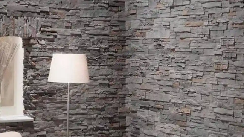 corner of a room with dark grey wall and a floor lamp with white shade on the left